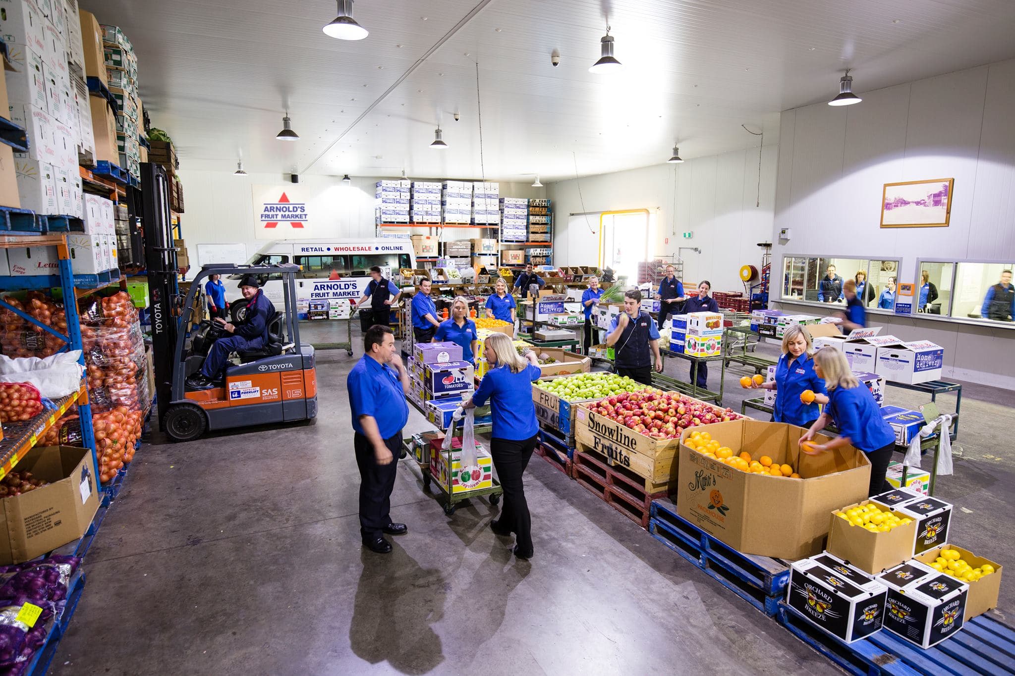 Arnold's team with produce by the heritage truck